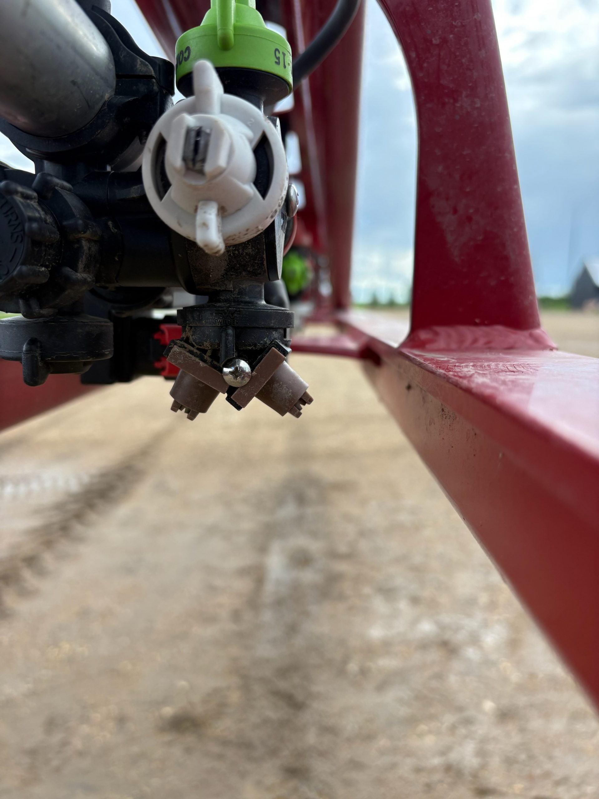 Dual Angle Max spray nozzle that has interference with the sprayer boom frame on an non-adjustable sprayer bracket